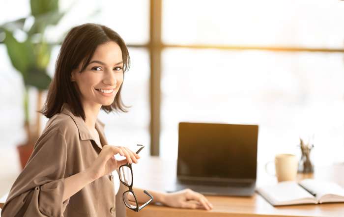 smiling-young-worker-with-blank-screen-laptop-YU7CVY8.jpg